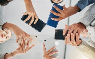 five people standing in a circle showing their phones