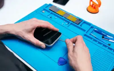 repairing cell phone on blue mat with screwdriver | Is Your Charging Port Really Broken? Here’s What Could Be Wrong