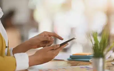 woman using mobile phone at workplace indoors | Repair or Replace? How to Decide What’s Best for Your Phone